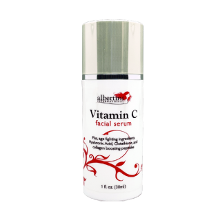 A bottle of vitamin c facial serum on a black background