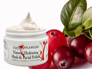 A jar of natural hydrating mask and facial polish next to some fruit.